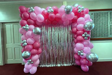 Hot pink and silver garland framing a foil fringe backdrop, built by Sherri's Heavenly Balloons in central Indiana.