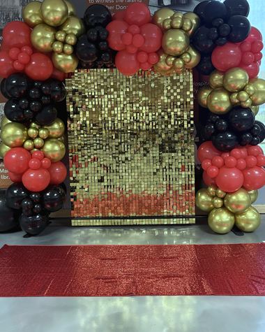 Red, black and chrome gold framing a gold shimmer wall, built by Sherri's Heavenly Balloons in central Indiana.