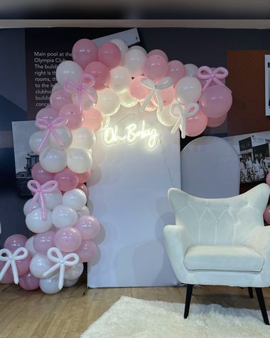 Blush and pearl garland with satin bows and a neon sign, built by Sherri's Heavenly Balloons in central Indiana.