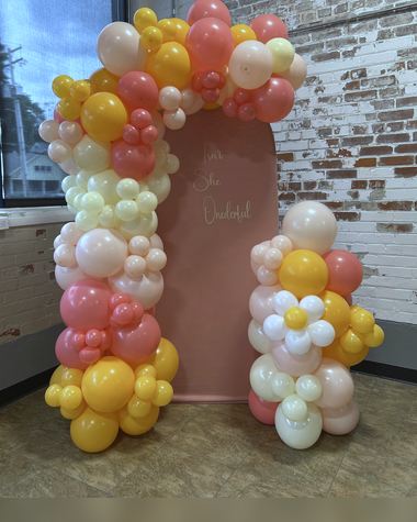 Coral, peach and cream garland on a brick doorway, built by Sherri's Heavenly Balloons in central Indiana.