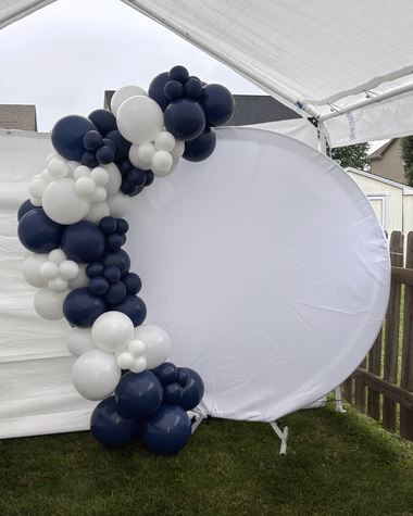Navy and white garland on a round backdrop, built by Sherri's Heavenly Balloons in central Indiana.