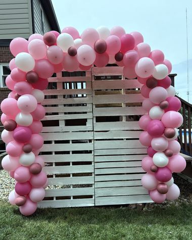 Hot pink and blush garland on a whitewashed pallet wall, built by Sherri's Heavenly Balloons in central Indiana.