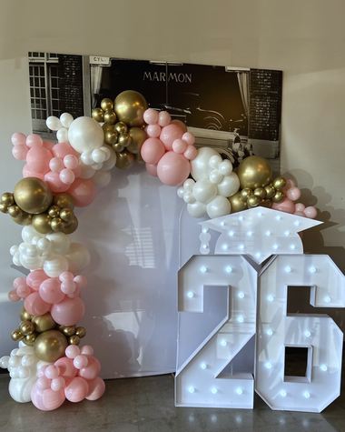 Blush, ivory and chrome gold over a lit marquee number, built by Sherri's Heavenly Balloons in central Indiana.