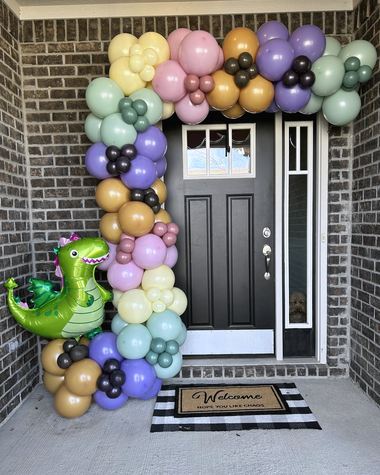 Sage, lilac and gold garland framing a front door, built by Sherri's Heavenly Balloons in central Indiana.