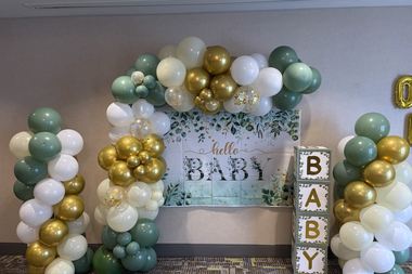 Sage, gold and white garland over a greenery banner, built by Sherri's Heavenly Balloons in central Indiana.