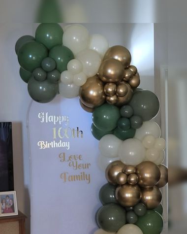 Forest green, gold and cream garland for a 100th birthday, built by Sherri's Heavenly Balloons in central Indiana.